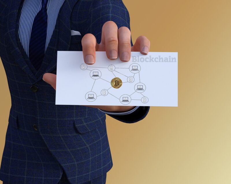 Man holding a card demonstrating blockchain technology.