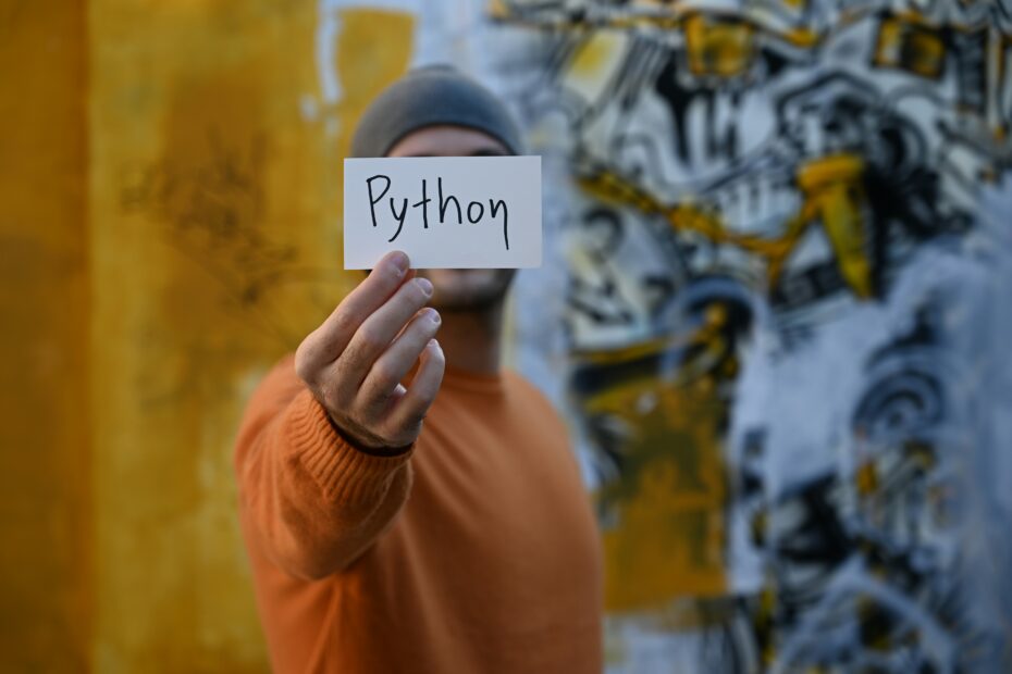 Man holding a paper reading python.